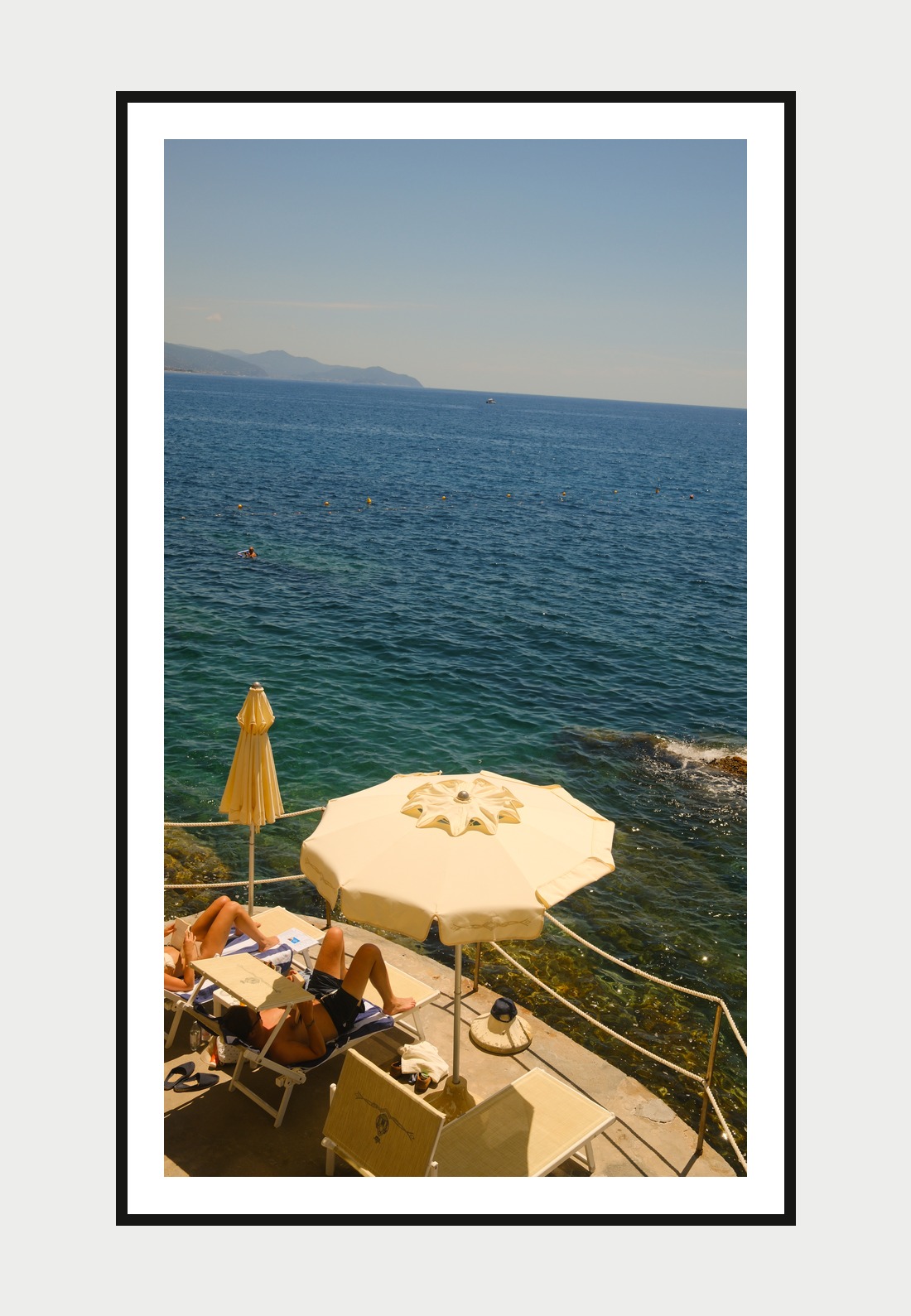 Framed print: umbrellas and sunbathers on a terrace above the sea, Portofino, Italy