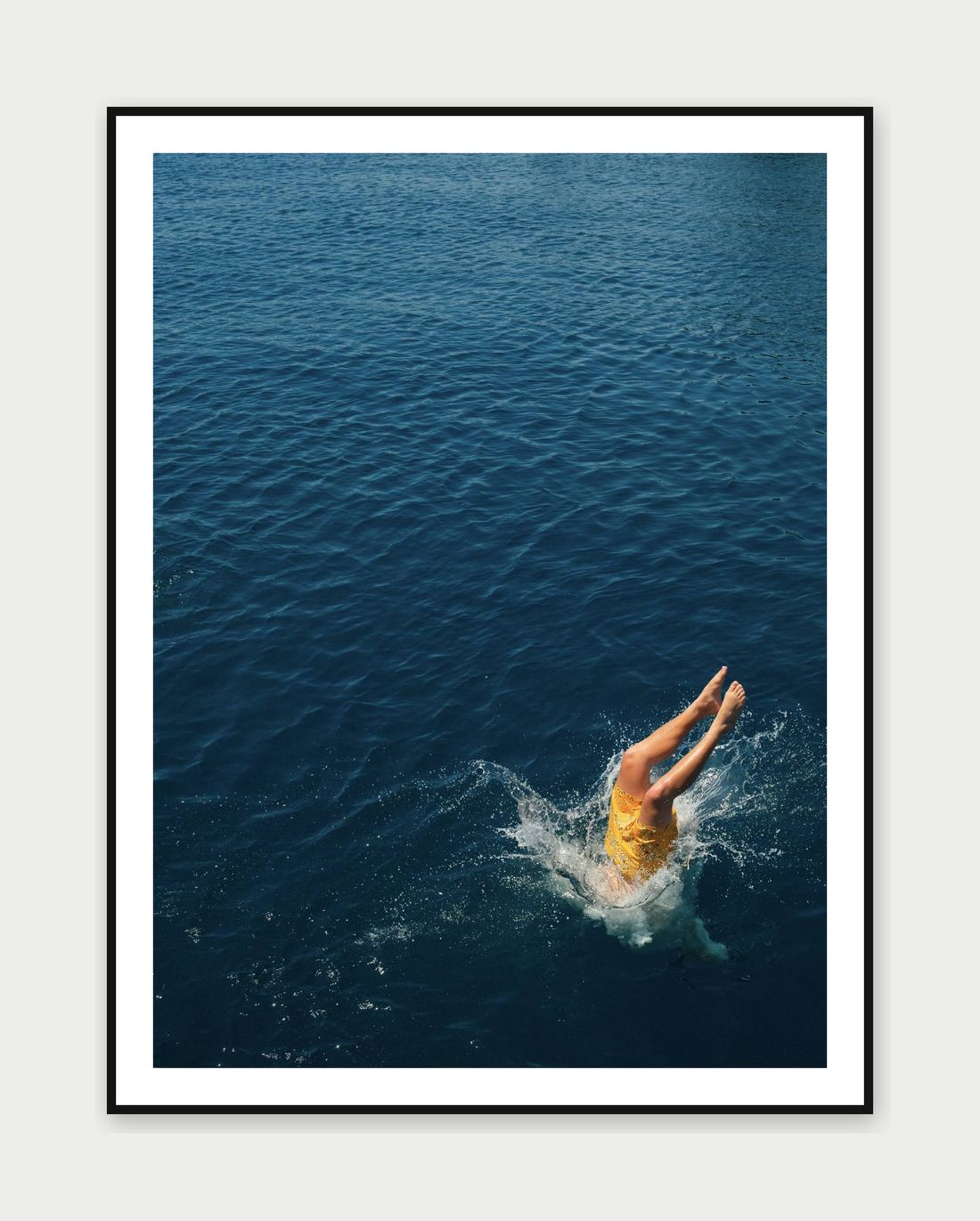 Framed print: a diver mid-air over deep blue water, Santorini, Greece